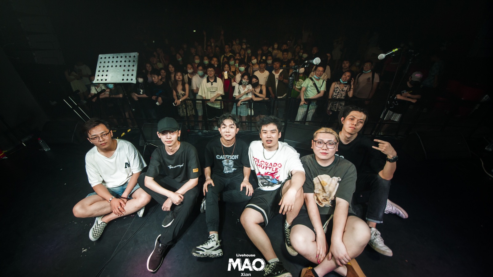 Older group photo with audience after a show
