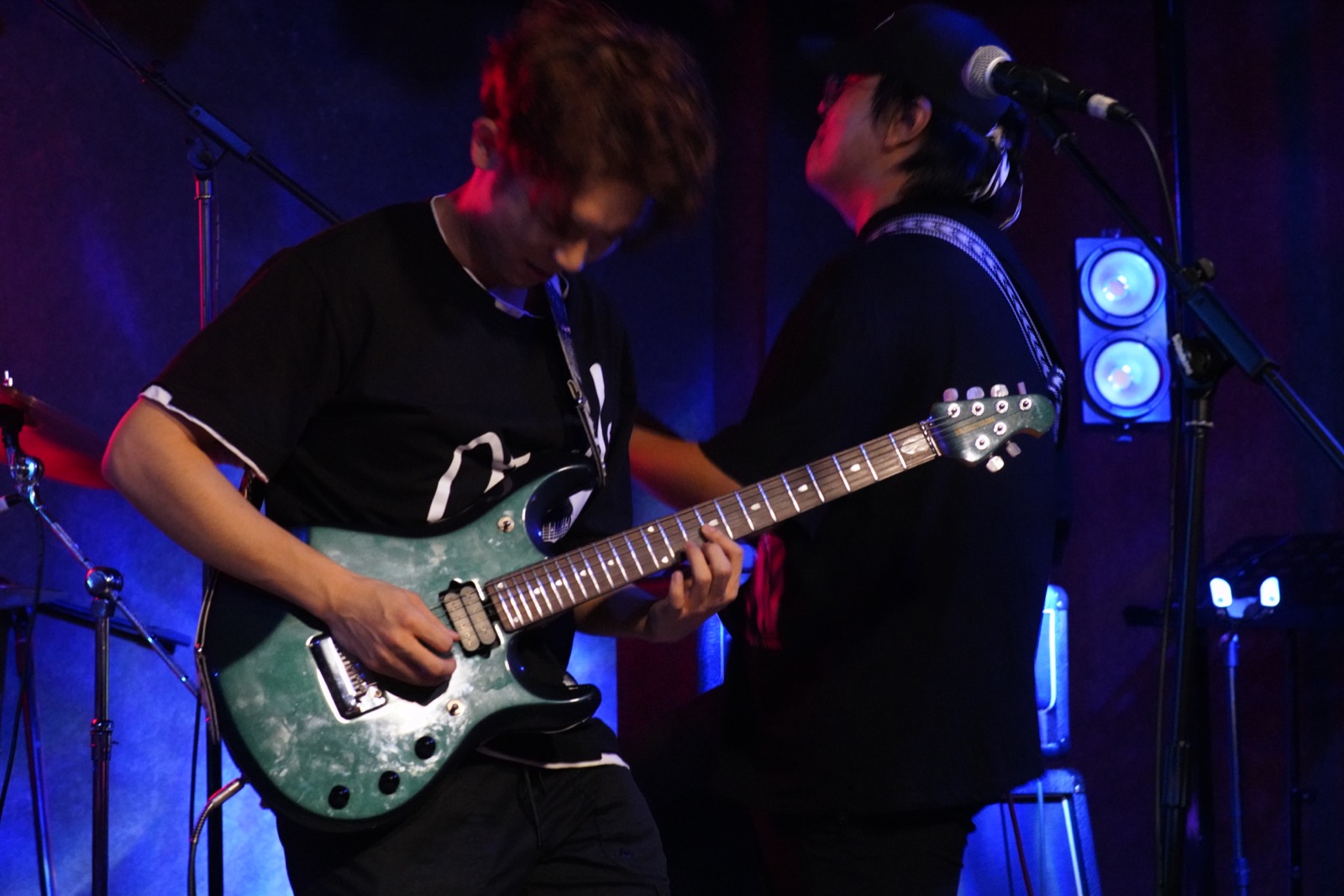 Older guitarist and vocalist on stage