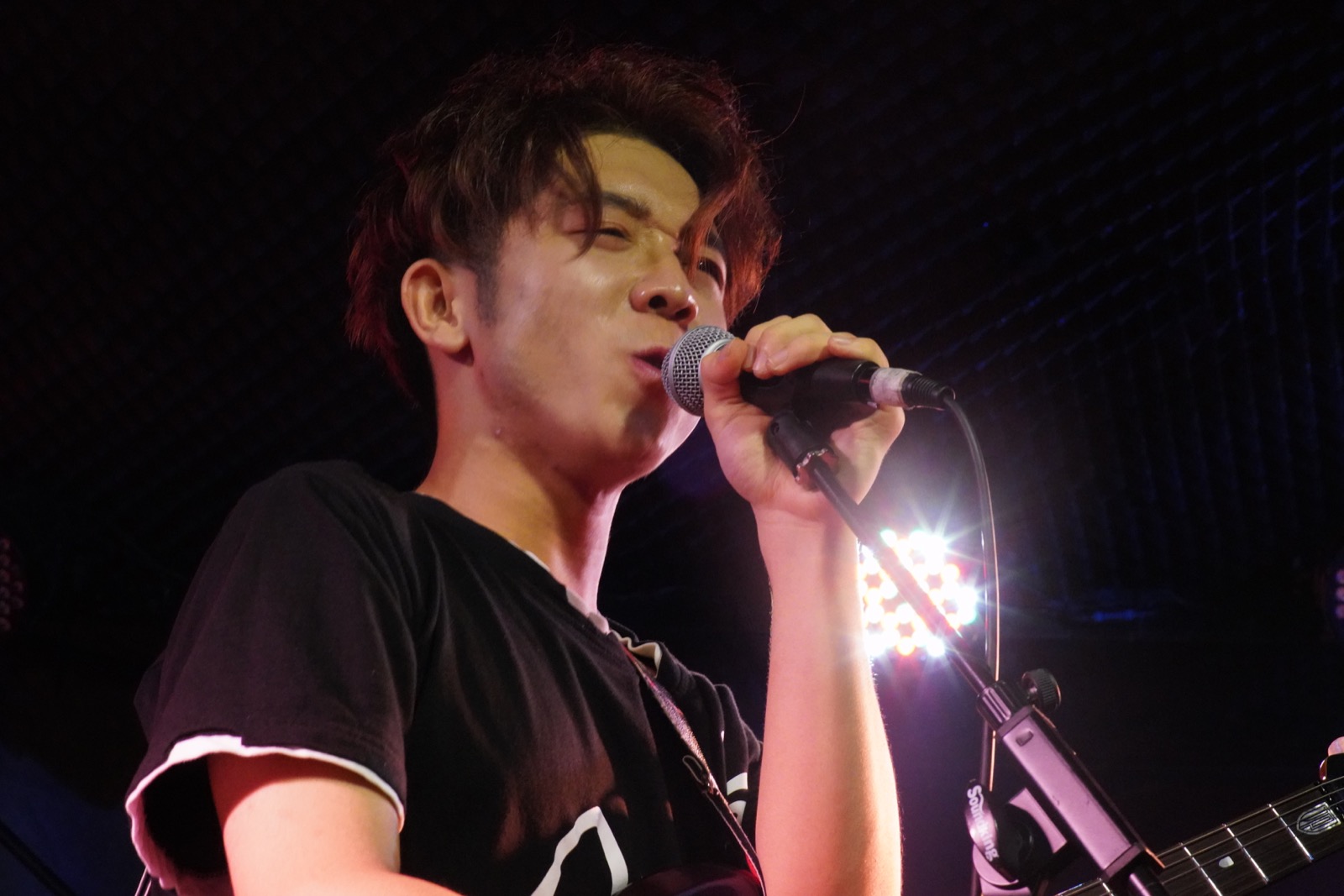 Older vocalist close-up with handheld microphone