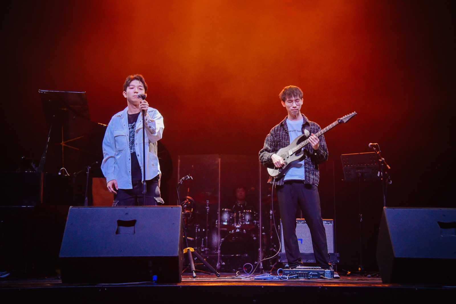 Older stage performance with orange lighting