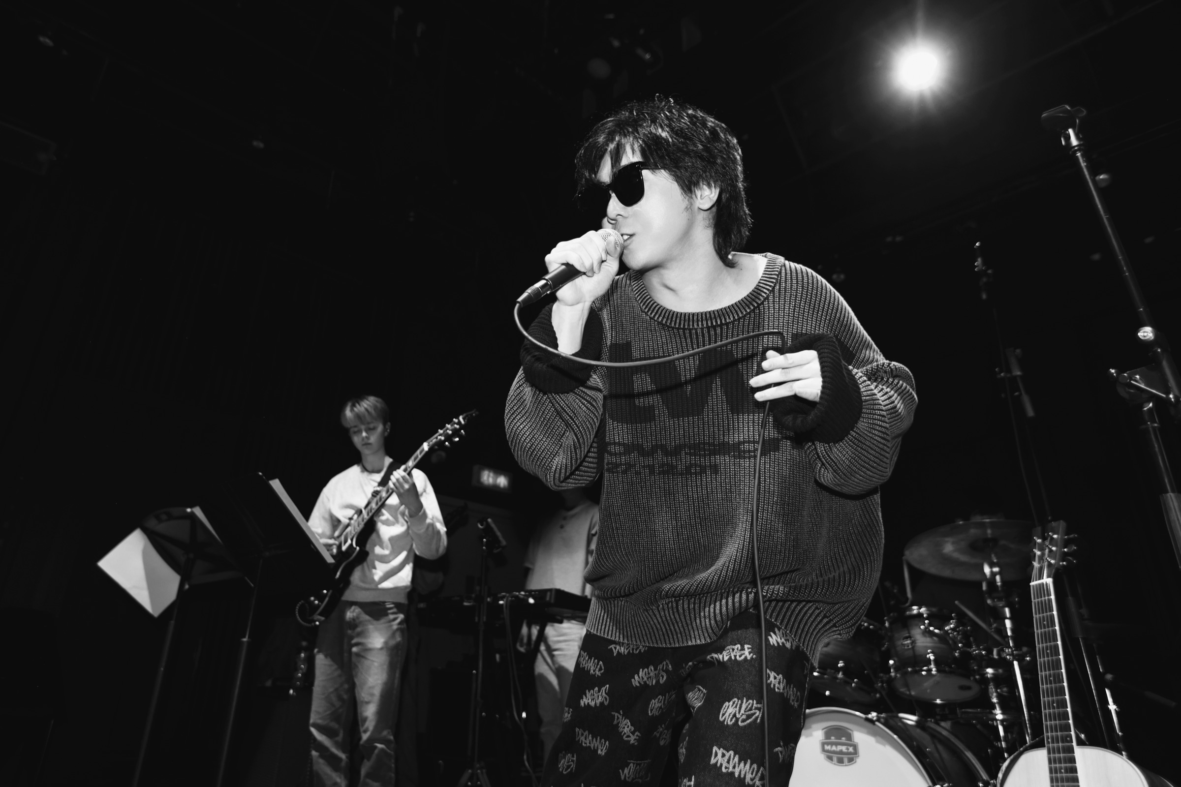 Bingchen Wu performing live with a microphone